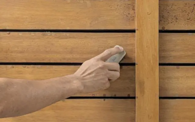 Hand sanding wood slats before finishing